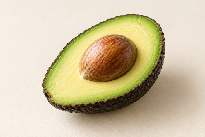 An avocado half on ivory, illustrating L-Glutathione.