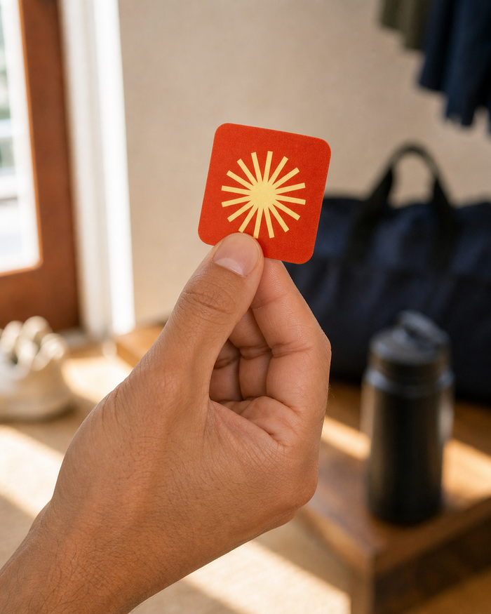 A man holding one Pure Patch Energy Patch after peeling it from the backing