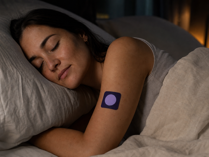 Woman sleeping with a Pure Patch Sleep Patch on her upper arm